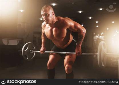 Athlete hands in powder and talc, barbell exercise. Strong weightlifter training with weight, bodybuilding workout. Athlete hands in powder and talc, barbell exercise