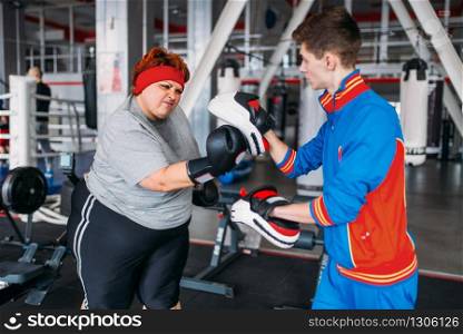 Athlete in sportswear, training on exercise machine in gym. Bearded man on workout in sport club, healthy lifestyle. Athlete in sportswear on exercise machine in gym