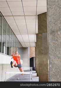 Athlete Jumping Over Hurdles in Arcade