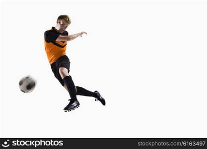 Athlete kicking soccer ball