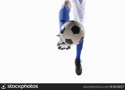 Athlete kicking soccer ball