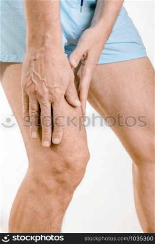 Athlete man massaging a painful quadriceps after an accident. It could a musculaire claquage or a muscle elongation