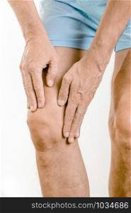 Athlete man massaging a painful quadriceps and the knee after a sport accident. It could be a quadriceps tendinopathy, a muscle elongation, a medial meniscus tears or bursitis