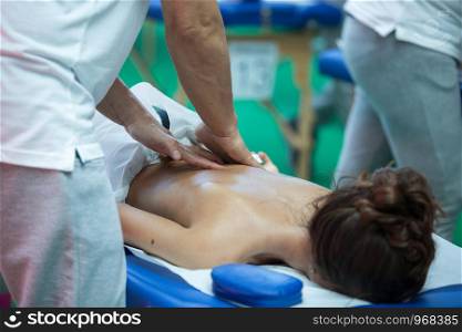 Athlete's Back Professional Massage on Bed after Sport Fitness Activity.. Athlete's Back Professional Massage on Bed after Sport Fitness Activity