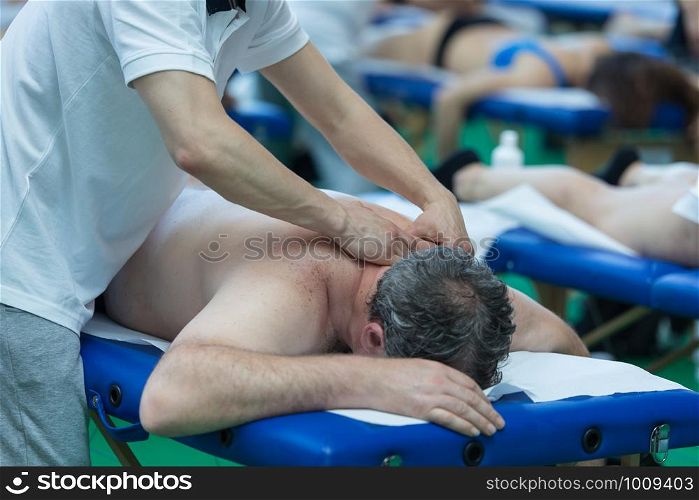 Athlete's Shoulders Professional Massage on Bed after Sport Fitness Activity.