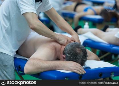 Athlete's Shoulders Professional Massage on Bed after Sport Fitness Activity.