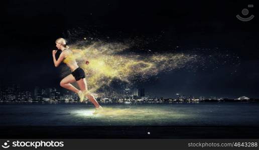 Athlete running fast. Running woman in sport wear on black background