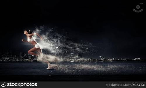 Athlete running fast. Running woman in sport wear on black background
