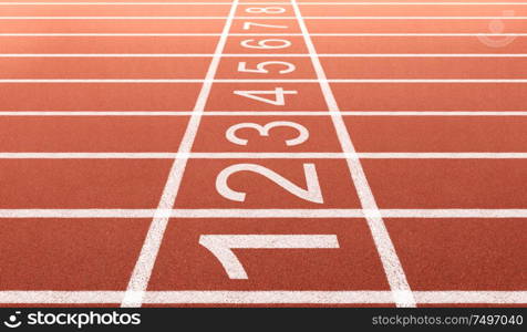 Athlete running track with number on the start . Side view and close-up angle .