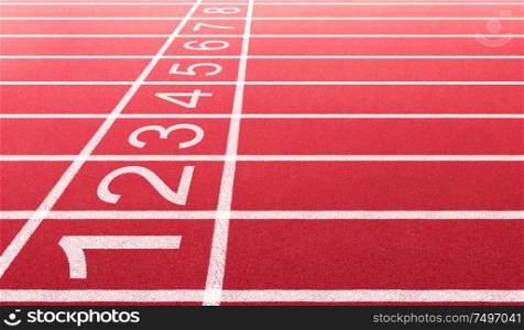 Athlete running track with number on the start . Side view and close-up angle .