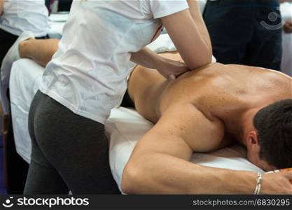 Athlete's Back Professional Massage after Fitness Activity by Young Masseuse, Wellness and Sport