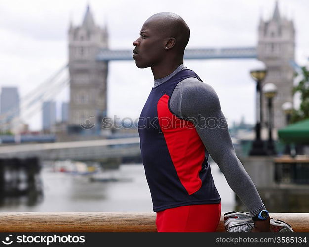 Athlete Stretching in Front of Tower Bridge