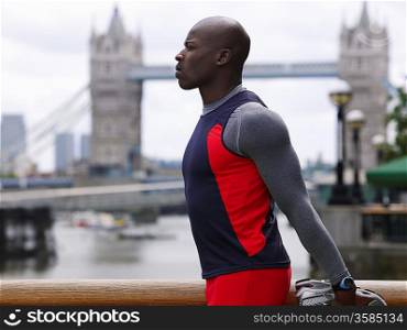 Athlete Stretching in Front of Tower Bridge