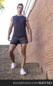 Athlete walking down the stairs of a stadium stand