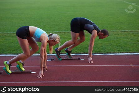 athlete woman group running on athletics race track on soccer stadium and representing competition and leadership concept in sport