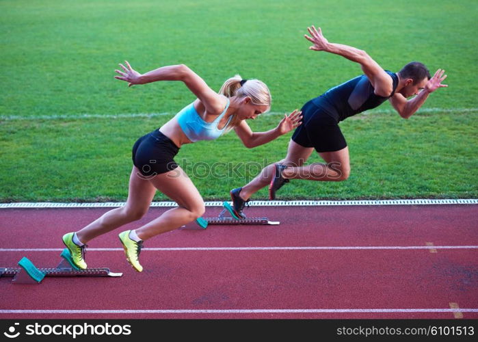 athlete woman group running on athletics race track on soccer stadium and representing competition and leadership concept in sport