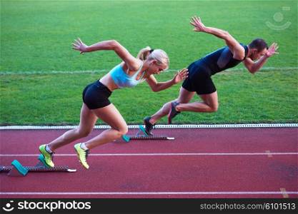 athlete woman group running on athletics race track on soccer stadium and representing competition and leadership concept in sport
