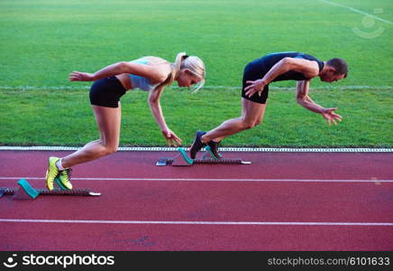 athlete woman group running on athletics race track on soccer stadium and representing competition and leadership concept in sport