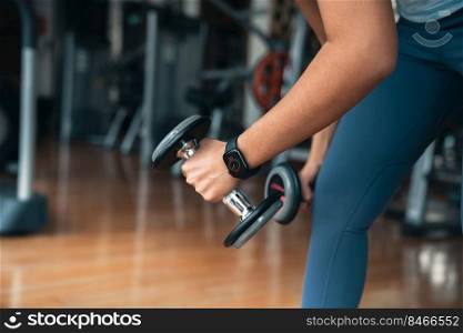 athlete woman lifting dumbbell, doing exercise at gym