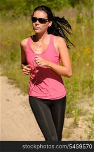 Athlete woman running training on sunny day with sunglasses