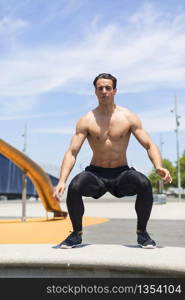 Athlete working out on cross fit jump box outside on a wall.