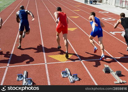 Athletes starting to run, rear view