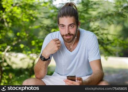 athletic guy listening to music on workout morning