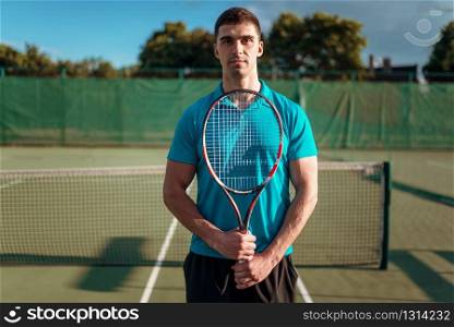 Athletic male tennis player plays on outdoor court. Summer season active sport game. Happy leisure. Athletic male tennis player plays on outdoor court
