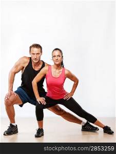 Athletic man and woman doing fitness exercise