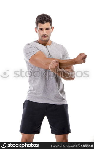 Athletic man doing some warming exercises, isolated over a white background