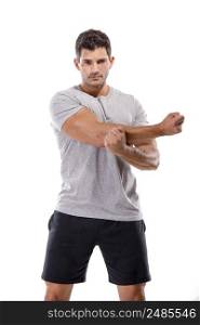 Athletic man doing some warming exercises, isolated over a white background