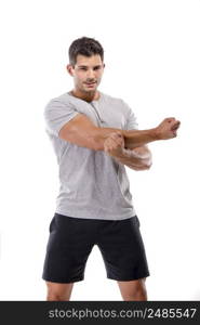 Athletic man doing some warming exercises, isolated over a white background