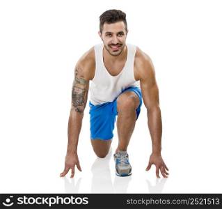 Athletic man ready to start running, isolated over a white background