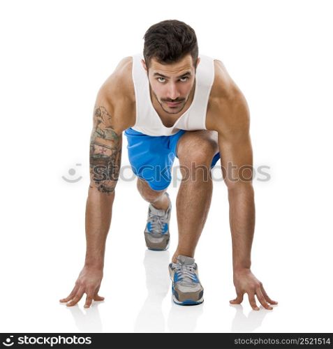Athletic man ready to start running, isolated over a white background