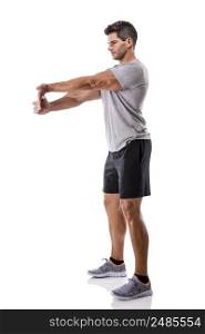Athletic man stretching arms, isolated over a white background