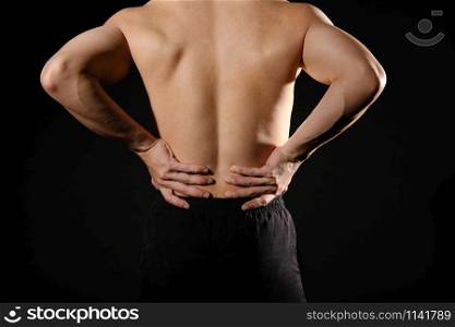 athletic muscular bodybuilder man with back pain backache. fitness workout injury concept