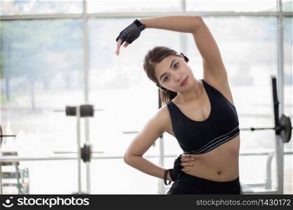 Athletic woman asian warming up and Young female athlete sitting on an exercising and stretching in a gym, healthy lifestyle concept,,soft focus