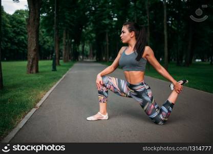 Athletic woman exercises, fitness training in park. Slim girl in sportswear, outdoor fit workout