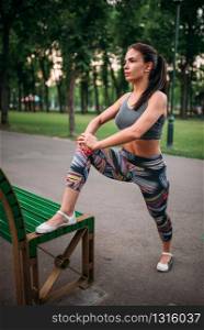 Athletic woman exercises, fitness training in park. Slim girl in sportswear, outdoor fit workout. Athletic woman exercises, fitness training in park