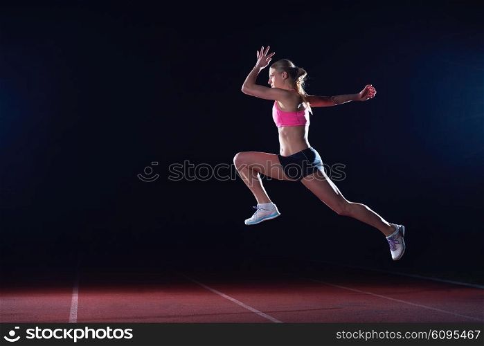 Athletic woman running on athletics race track