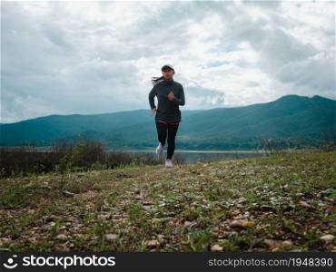 Athletic woman running on forest trail. Female runners running in nature in the morning. Workout Healthy lifestyle concept.