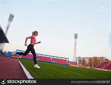 Athletic woman running onrace track