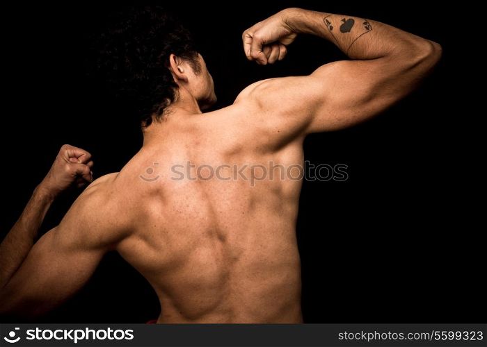 Athletic young man flexing his muscles