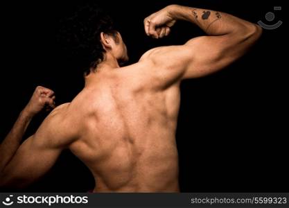 Athletic young man flexing his muscles