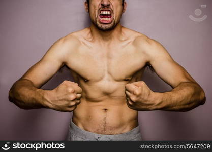 Athletic young man flexing his muscles