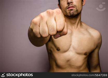 Athletic young man throwing punches