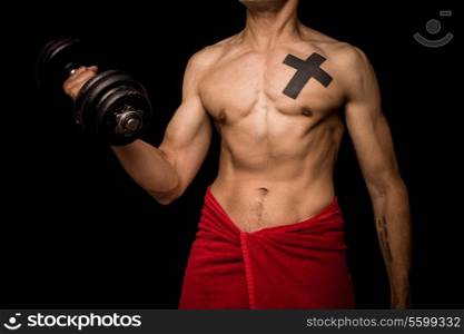 Athletic young man working out with dumbbell