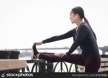 athletic young woman exercising outdoors