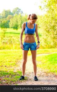 athletic young woman in sportswear exercising in a park in the morning