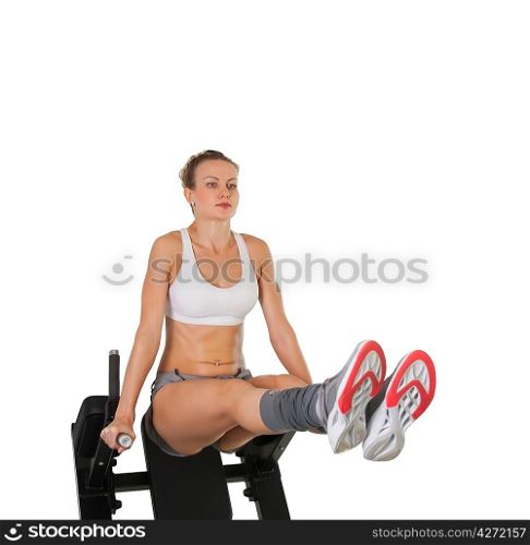 Athletic young woman training on exerciser isolated on white